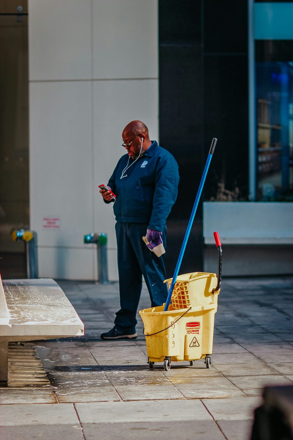 Commercial cleaner with mop bucket outside an office building - Good Taste Cleaning Services