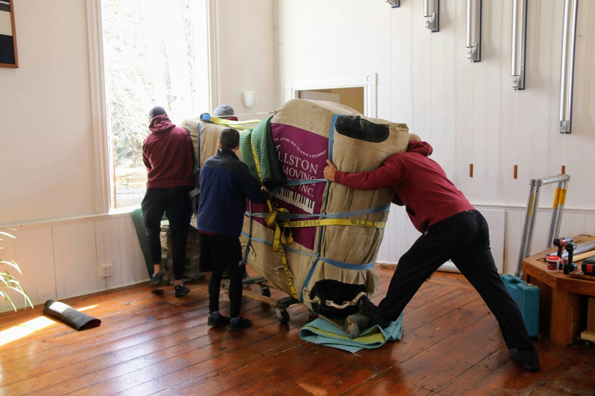 Movers clearing a home for move-out cleaning - Good Taste Cleaning Services