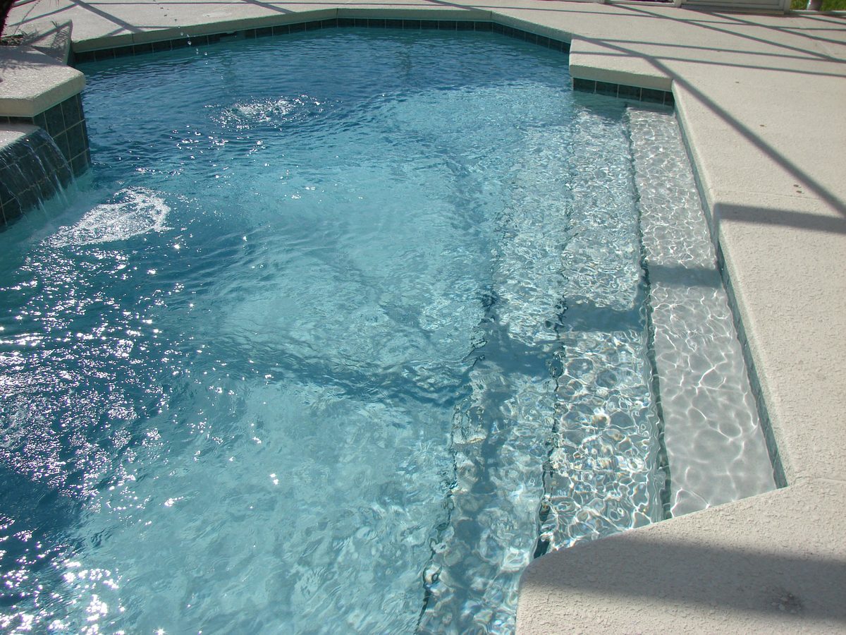 Clean sparkling swimming pool with clear water - Good Taste Cleaning Services
