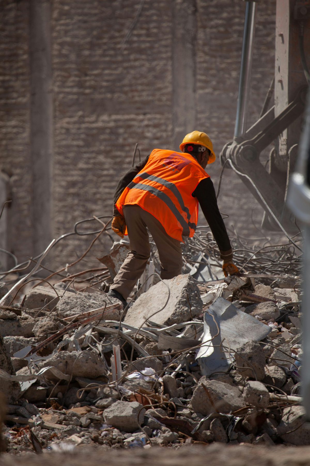 Construction worker clearing debris and rubble on a job site - Good Taste Cleaning Services